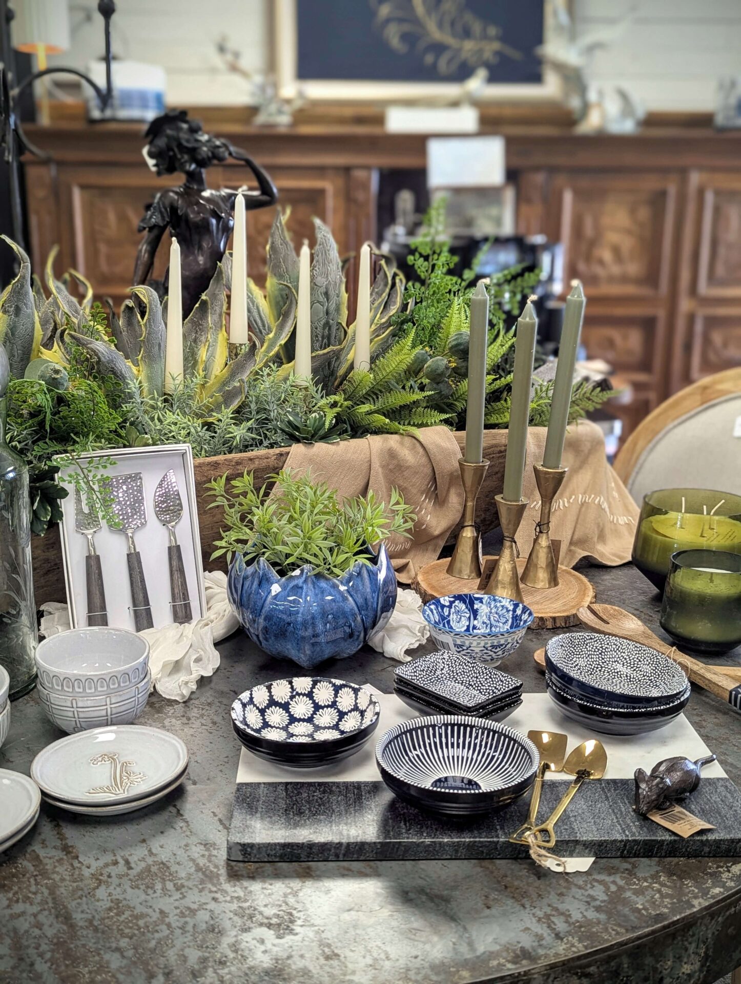 Assorted decorative bowls on a dining room table. The background showcases candles and home accessories.